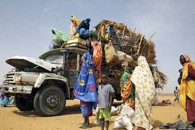Displaced people arriving at a camp at El Fasher, Darfur.