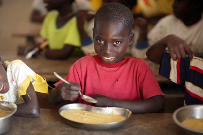 Children in Guinea-Bissau eating food donated by the World Food Programme.