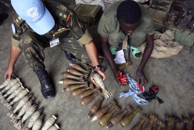A United Nations peacekeeper inspects an arms cache in DR Congo (file photo).