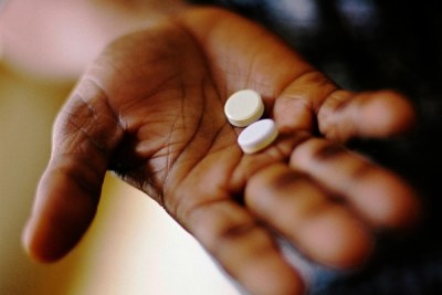A patient holds drugs: there are more than two million HIV positive people in Tanzania.