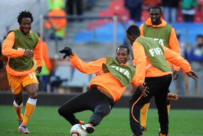 Ivory Coast's Didier Drogba, middle, warms up prior to kick-off with teammates