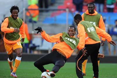 Ivory Coast's Didier Drogba (center) warms up prior to kick off with teammates (file photo).