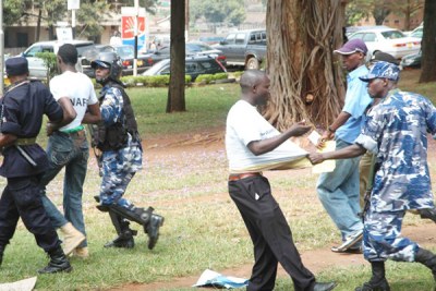 Police arrest demonstrators at Railway Grounds in Kampala on 27 July 2010.