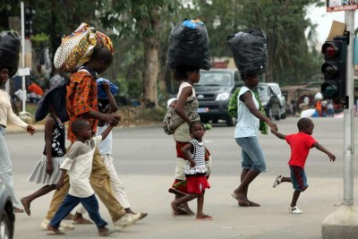 A family flees the Abobo neighbourhood of Abidjan.
