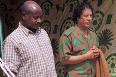 Ugandan President Yoweri Museveni (L) and Libya's Muammar al-Gaddafi.