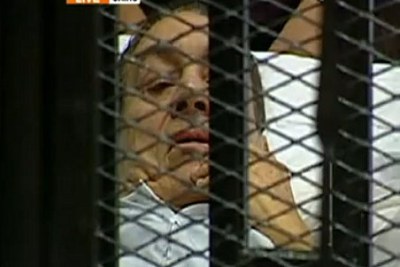 Al Jazeera television broadcast live the appearance of former President Hosni Mubarak, confined to a cage in the courtroom.
