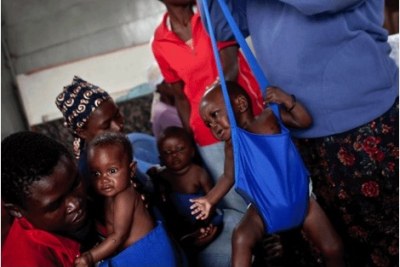 A malnourished child being weighed: The Sahel region spanning Senegal, Gambia, Mauritania, Mali, Niger, Burkina Faso, and Chad is grappling with food insecurity and malnutrition.