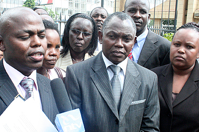 Chairman of the Kenya Private Schools Association, John Kabui Mwai (centre) and lawyer Chege Wainaina (left) address the press on January 18, 2011 after the mention of a case challenging the new Form One selection policy.