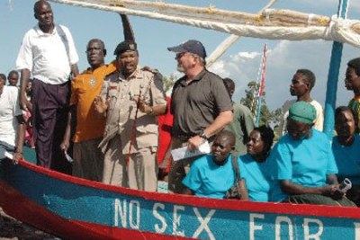 Kisumu East DC Mabeya Mogaka (third left) joins the No Sex for Fish women group during the donation of six boats by the US Peace Corps Kenya at Nyamware Beach in Kano, Kisumu County.
