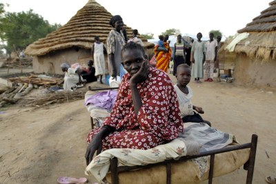 A woman and her daughter seek shelter after fleeing from her home in Abyei (file photo).