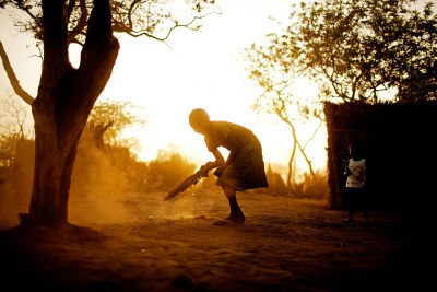 A young girl sweeps her family compound in the Yida refugee camp, South Sudan, April 2012.