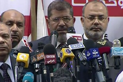 Egypt's first elected President Mohamed Mursi, middle, address the media (file photo).