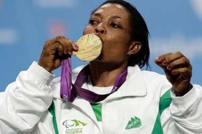 Gold medallist Esther Oyema of Nigeria kisses her medal during the Victory Ceremony for the womens -48 kg Powerlifting at ExCeL.