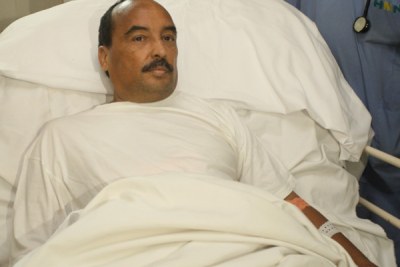 President Abdel Aziz in his French hospital bed after being shot in an apparent accident.