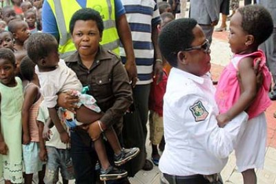 Nollywood stars Chinedu Ikedieze and his friend Osita Iheme (Aki and Pawpaw) during a visit to some of the flood displaced persons in ICE camp, Asaba, Monday.