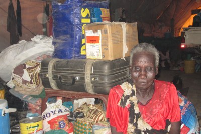 Shilluk woman with all her belongings in an UNMISS warehouse in South Sudan.