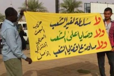 Ba’ath Party members raise a banner reading “No to power except people’s power” at a protest in Khartoum.
