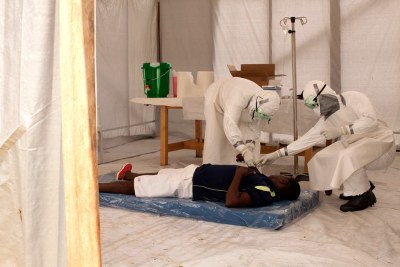 Hospital staff respond to a suspected Ebola patient in the triage tent in Monrovia (file photo).