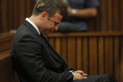 Paralympic athlete Oscar Pistorius cries while seated in the dock during the verdict in his murder trial in Pretoria, Thursday, 11 September 2014.