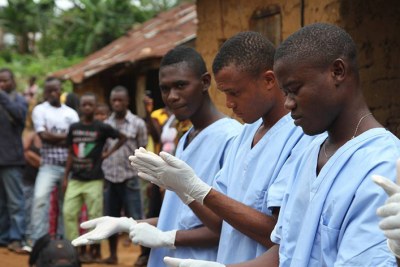 Volunteers work with the Red Cross to prevent and treat Ebola cases.