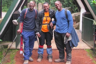 Zoe Wanjiru, centre, with clients at one of the entrances to Mount  Kilimanjaro.