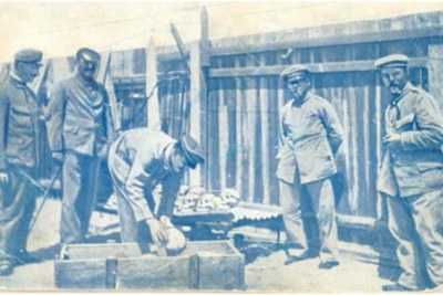 German soldiers loading skulls and bones of massacred Herero into a casket for shipping to Germany.