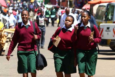 Students return to their homes on September 19, 2015, a day after the government ordered that all public and private schools be closed indefinitely because of the ongoing teachers' strike. Activists have planned a series of protests to press the government to reopen schools.
