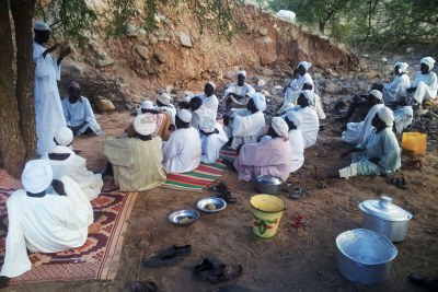 The men from Leeba gathered under the tree to read the Koran, pray to God to avoid any Antonovs bombing the area, and chat