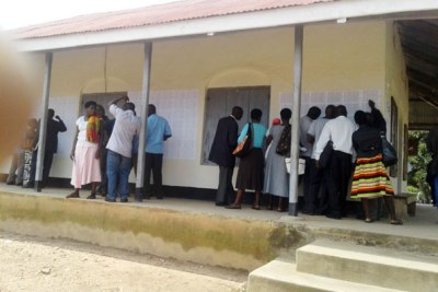 Public servants in Rukungiri District check for their names on the notice board to find out whether they are on the payroll.