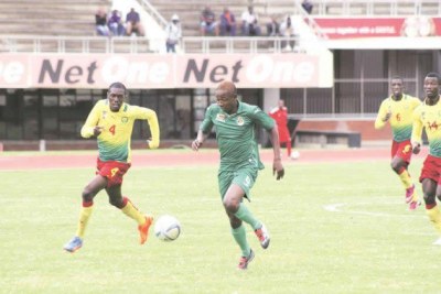 Young Warriors forward Prince Dube (right) charges towards goal under the close attention of Cameroon defender Grace Makani