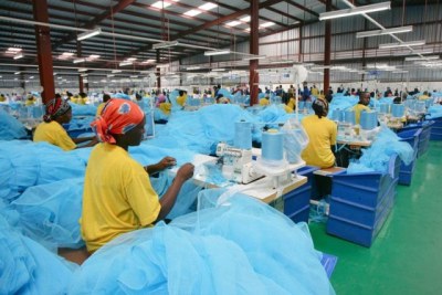Workers at A to Z textile in Arusha put final touches on bedsheets (file photo).