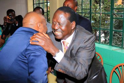 Coalition for Reforms and Democracy leader Raila Odinga embraces Gatundu South MP Moses Kuria before a lunch event at the Ranalo Foods restaurant in Nairobi on June 21, 2016.
