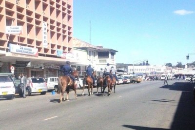 Police on horseback patrol the streets of Harare.