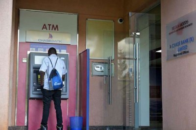 A customer at an ATM at the Chase Bank head office branch in Nairobi.