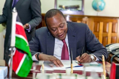 President Uhuru Kenyatta signing into law the 2015 Banking (Amendment) Bill at the State House.