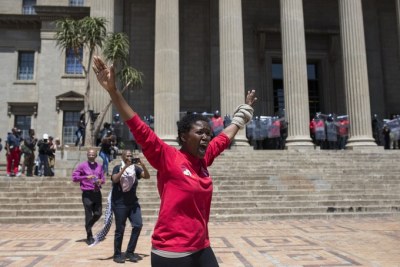 A student tries to calm the situation after clashes broke out at the Great Hall at Wits University.