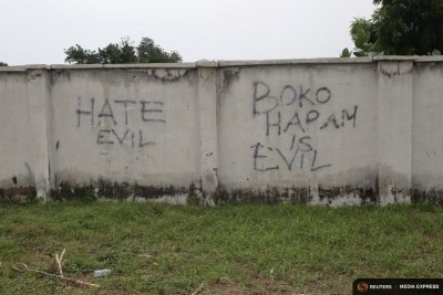 Writings describing Boko Haram are seen on the wall along a street in Bama, Borno, on August 31, 2016.