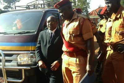 Rwenzururu king Charles Wesley Mumbere arrives at court accompanied by prison warders for his bail hearing.