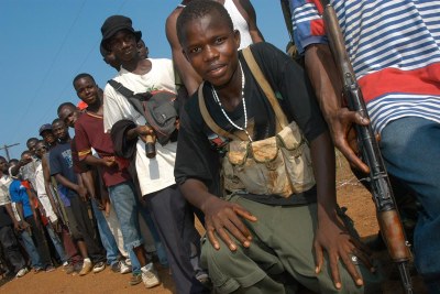 As part of the Disarmament, Demobilization, Rehabilitation and Reintegration (DDRR) process, former rebels in Liberia wait to exchange their weapons for cash. They will also attend training for reinsertion into civilian life.