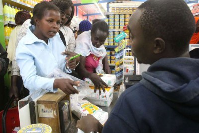 Residents of Maua, Meru County, pay for subsidised maize flour at Society Stores Supermarket on May 22, 2017.