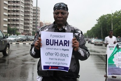 Nigeria’s singer Charles Oputa, popularly called Charly Boy, carries a placard to demand that ailing President Mohammadu Buhari resume work or resign in Abuja.