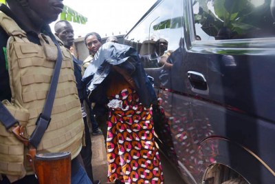 Abel Katende’s wife Janet Namugenyi being led away by police.