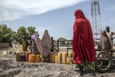 Women and children collect water in Mafa IDP camp, Borno state, north-east Nigeria.