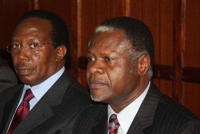 Former Kenya Power and Lighting managing director Samuel Gichuru (left) and former Finance minister Chris Okemo follow proceedings of their extradition case at the High Court on July 11, 2011.