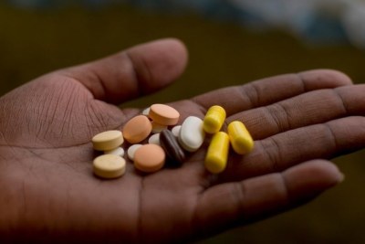 A South African patient prepares to take her medication for drug-resistant TB.