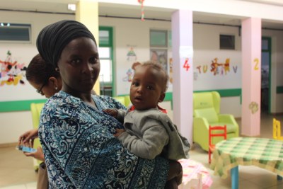A mother holding her child at the Santiago Norte Hospital in cape Verde.