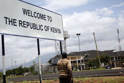 A man crosses into Kenya from Tanzania at Taveta/Holili border post. Dar es Salaam remains opposed to issuance of work permits to Kenyan nationals to work in its territory.
