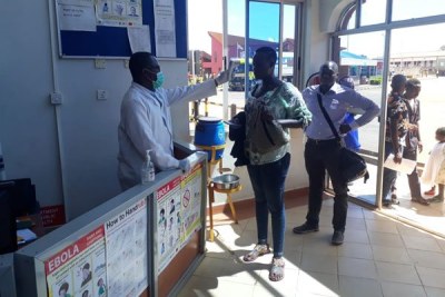 Travellers are screened for the Ebola virus before getting into Kenya at the Busia One Stop Border Post on June 12, 2019, following three confirmed cases in Kasese, western Uganda.