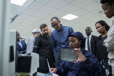 President Kagame together with other officials (L-R); Ashish Thakkar, the CEO of the Mara Group, Clare Akamanzi, the chief executive of Rwanda Development Board and the Minister for ICT and Innovation Paula Ingabire inspect one of the production units of Mara Phones.