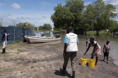 A UNICEF staff member with children in flood-affected Pibor Town, South Sudan